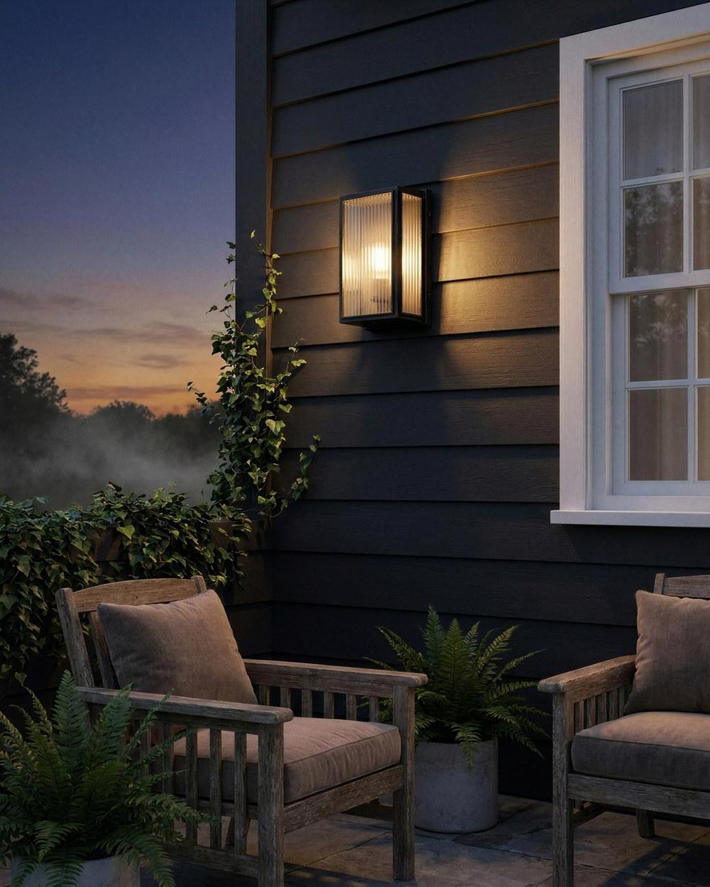 Trentham contemporary outdoor wall light in antique black on a weatherboard facade