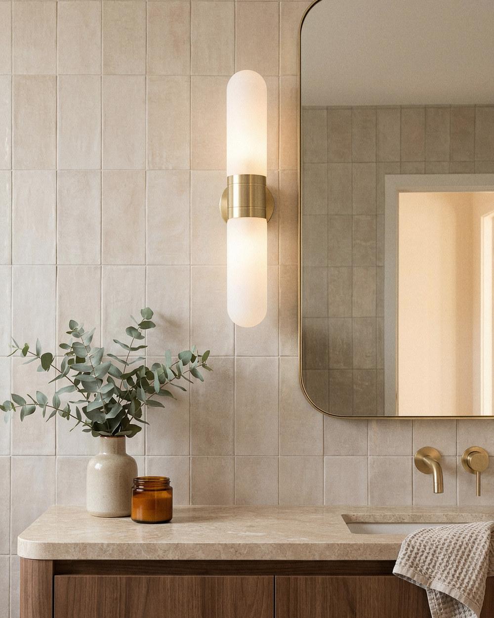 Mid-century tube wall light in satin brass in a bathroom