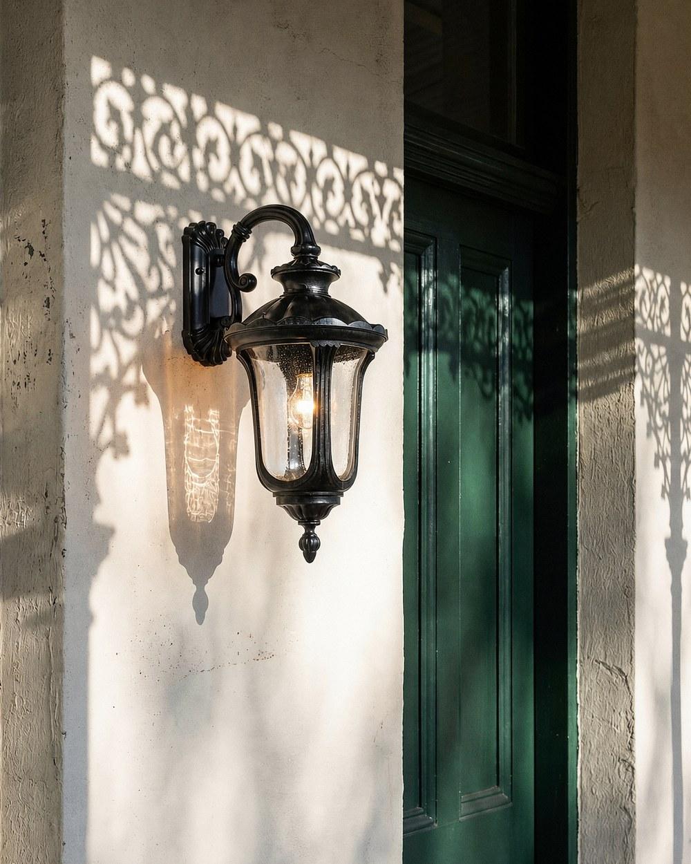 Waterford outdoor wall light in antique black mounted beside a green front door